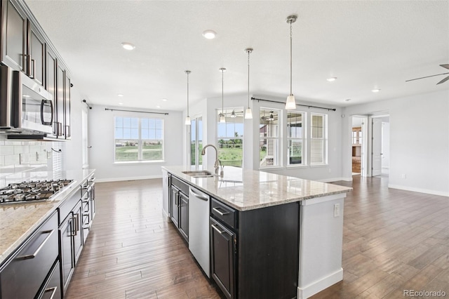27196 E Alder Dr, Aurora, CO 80016 - kitchen featuring appliances with stainless steel finishes, dark wood-style flooring, open floor plan, a ceiling fan, and recessed lighting