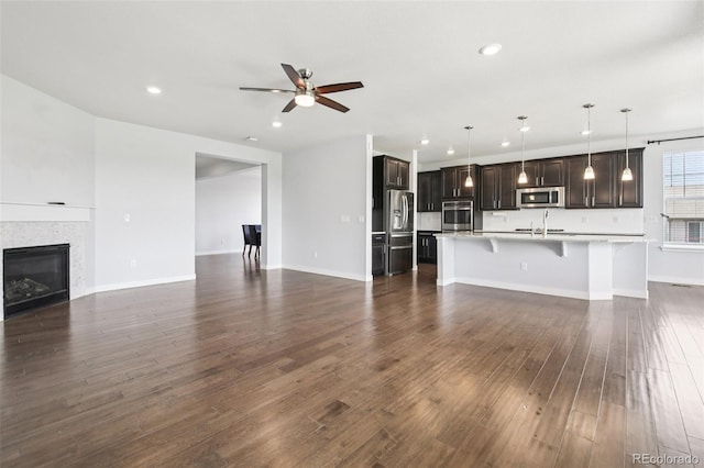 27196 E Alder Dr, Aurora, CO 80016 - unfurnished living room featuring ceiling fan, recessed lighting, dark wood finished floors, and a fireplace