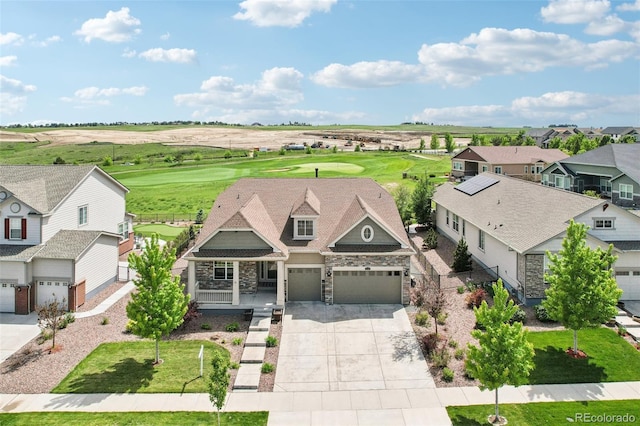 27196 E Alder Dr, Aurora, CO 80016 - view of front of home featuring stone siding, driveway, a residential view, view of golf course, and covered porch