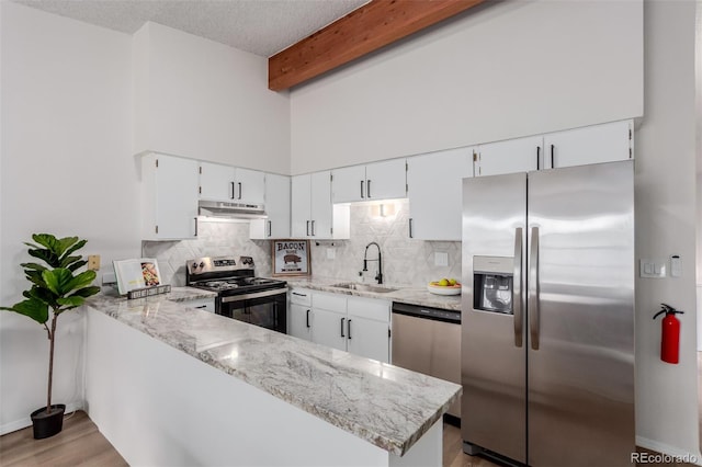 2620 S Federal Blvd Unit K, Denver, CO 80219 - kitchen with appliances with stainless steel finishes, under cabinet range hood, decorative backsplash, light stone countertops, and beamed ceiling
