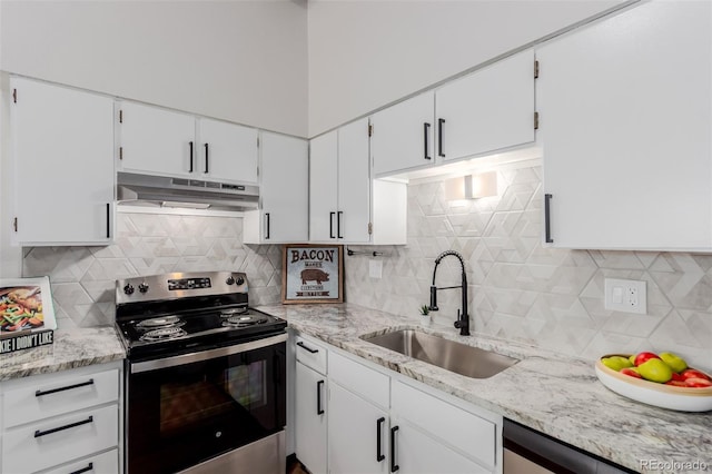 2620 S Federal Blvd Unit K, Denver, CO 80219 - kitchen with stainless steel appliances, under cabinet range hood, tasteful backsplash, and white cabinetry