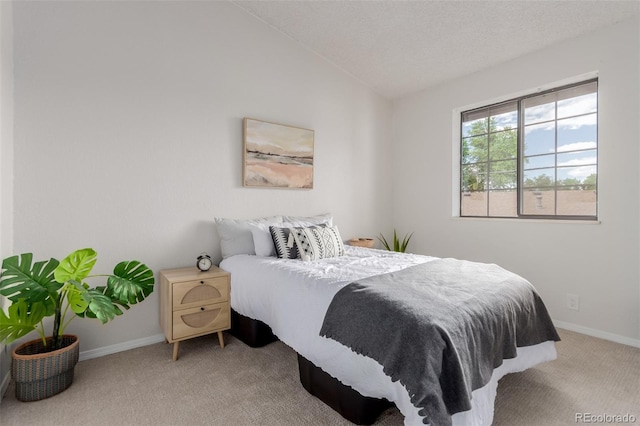 2620 S Federal Blvd Unit K, Denver, CO 80219 - carpeted bedroom featuring lofted ceiling and baseboards