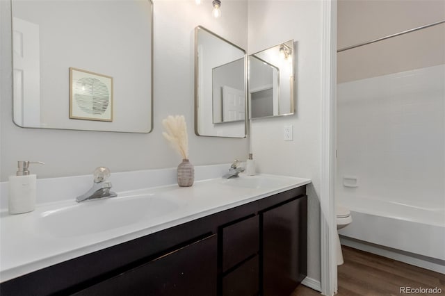 2620 S Federal Blvd Unit K, Denver, CO 80219 - bathroom featuring double vanity, wood finished floors, and bathing tub / shower combination