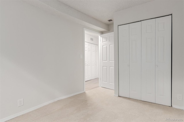 2620 S Federal Blvd Unit K, Denver, CO 80219 - unfurnished bedroom featuring light colored carpet and a closet