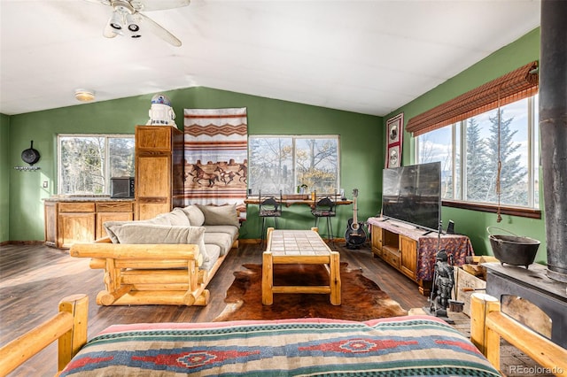 sunroom / solarium with a healthy amount of sunlight, ceiling fan, and vaulted ceiling