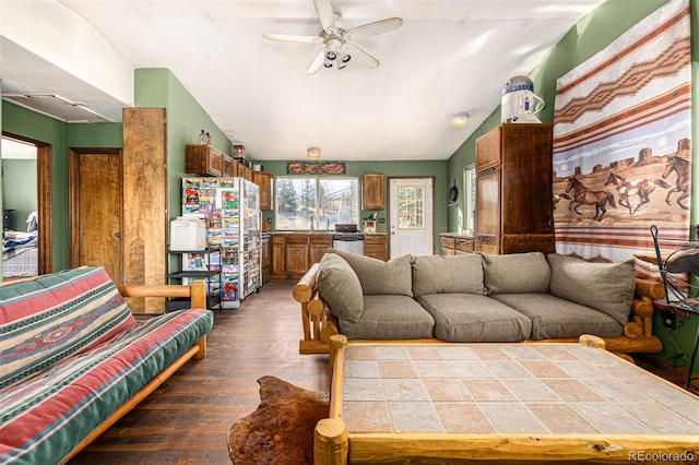 living room featuring dark wood-type flooring, lofted ceiling, and ceiling fan