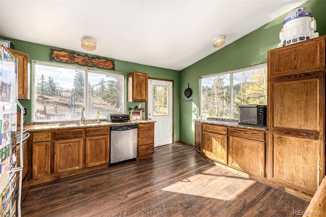 kitchen with a healthy amount of sunlight, vaulted ceiling, stainless steel dishwasher, and dark hardwood / wood-style floors