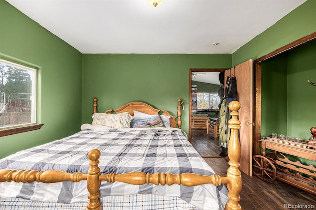 bedroom with dark hardwood / wood-style flooring