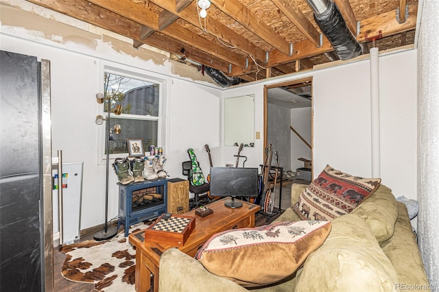 basement featuring hardwood / wood-style flooring and black refrigerator