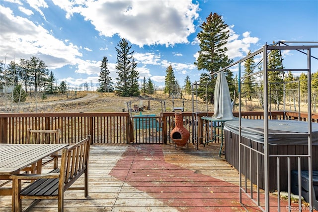 wooden terrace featuring a hot tub