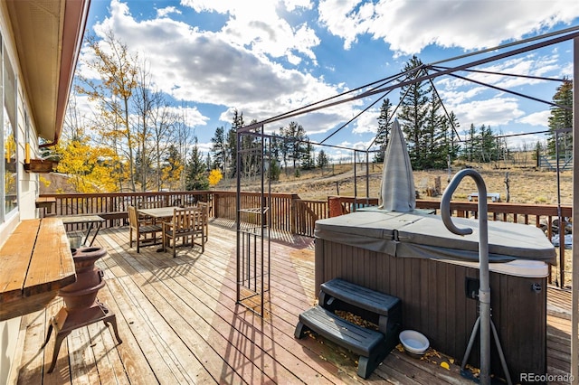 wooden deck featuring a hot tub