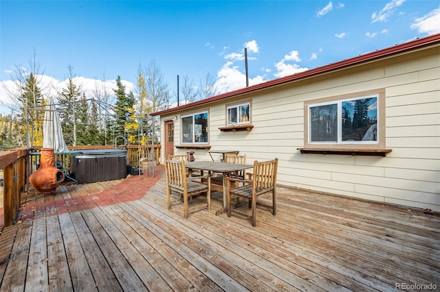 wooden deck featuring a hot tub