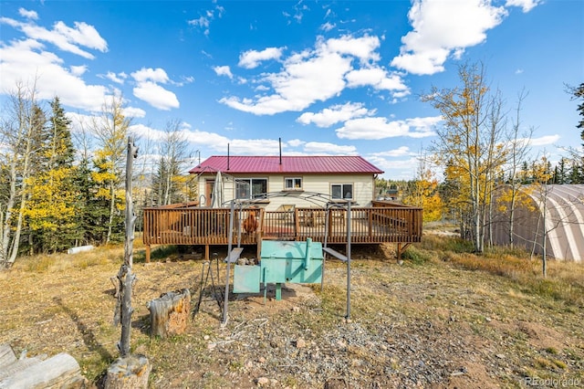 back of property with a wooden deck