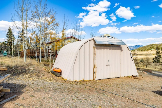 view of outbuilding featuring a mountain view