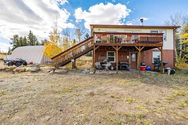 back of house featuring a wooden deck