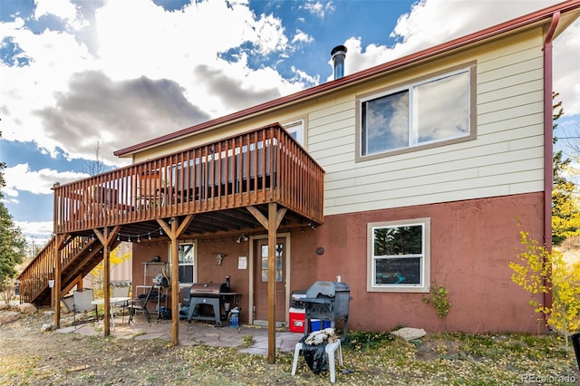 rear view of house with a patio and a deck