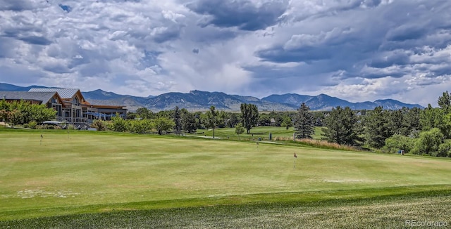 view of community featuring a lawn and a mountain view