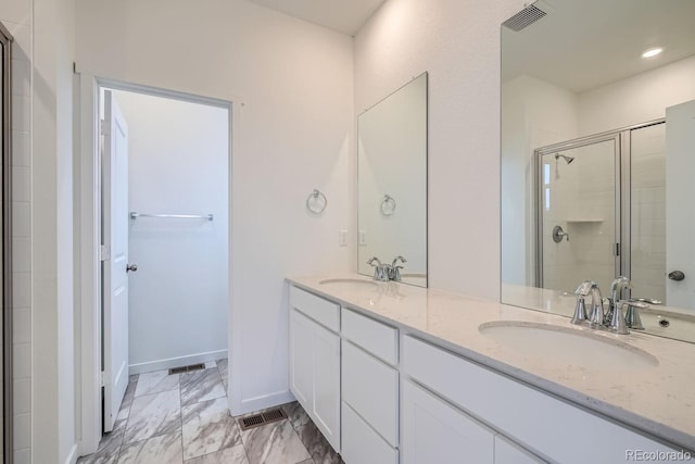 bathroom featuring vanity and an enclosed shower