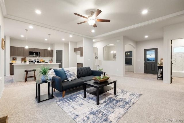 carpeted living room with ceiling fan