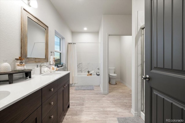 full bathroom with shower / bath combination with curtain, vanity, toilet, and hardwood / wood-style floors