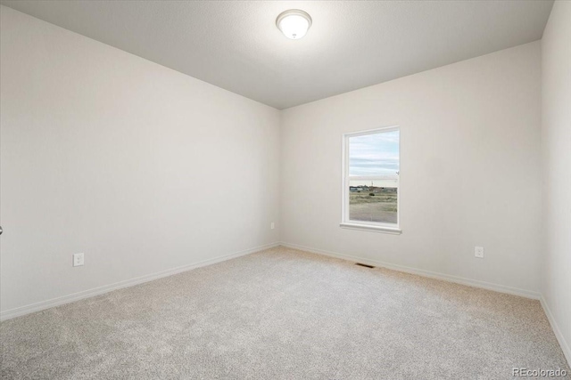 unfurnished room featuring carpet flooring