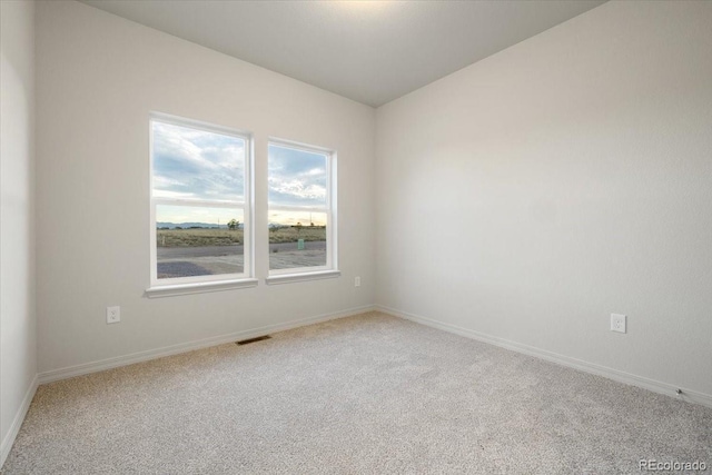 unfurnished room featuring carpet flooring