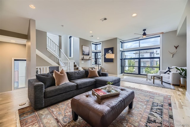 6849 E Lowry Blvd, Denver, CO 80230 - living room with light wood-style floors, a ceiling fan, stairs, recessed lighting, and baseboards