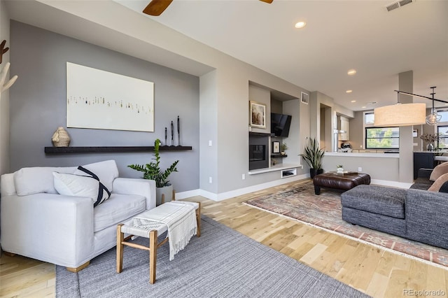 6849 E Lowry Blvd, Denver, CO 80230 - living room with wood finished floors, a ceiling fan, recessed lighting, and baseboards