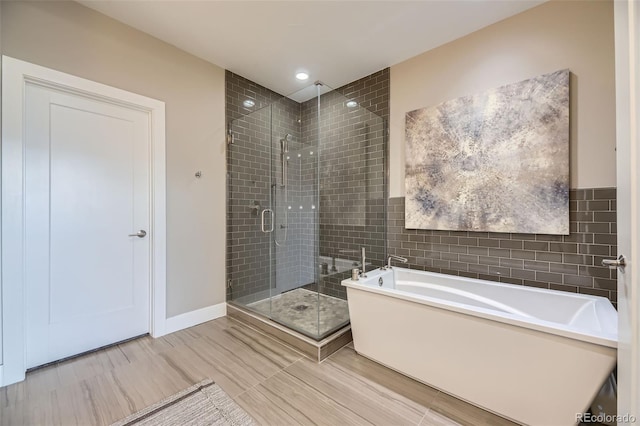 6849 E Lowry Blvd, Denver, CO 80230 - bathroom with a shower stall, a bath, tile walls, and recessed lighting