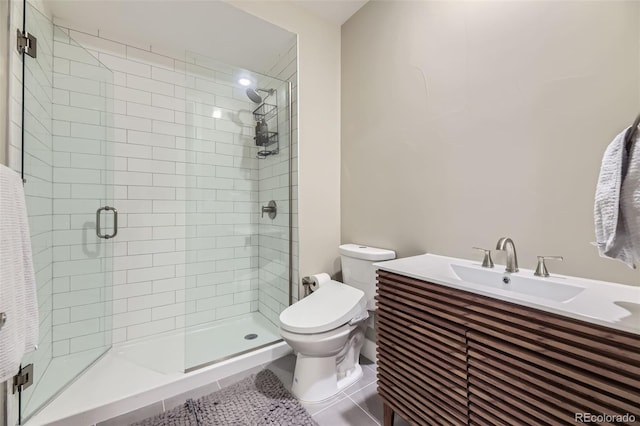 6849 E Lowry Blvd, Denver, CO 80230 - bathroom featuring a shower stall, toilet, vanity, and tile patterned flooring