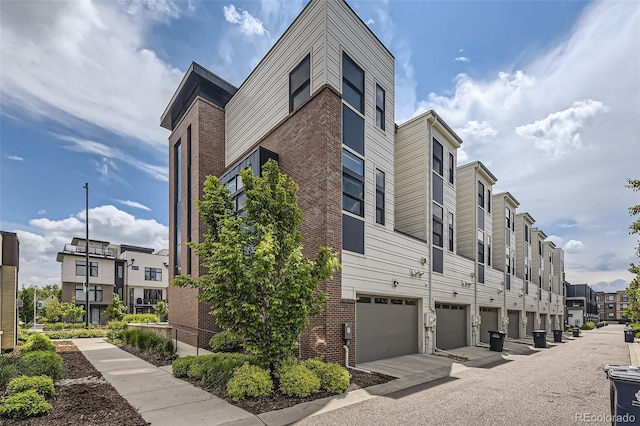6849 E Lowry Blvd, Denver, CO 80230 - view of building exterior featuring a garage and a residential view