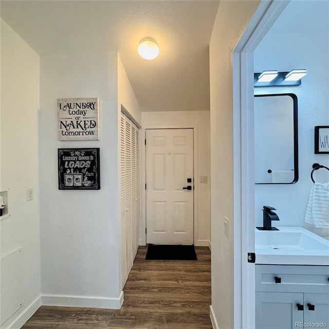7200 E State Highway 14 Unit 27, Fort Collins, CO 80524 - hallway with a sink, dark wood-style flooring, and baseboards