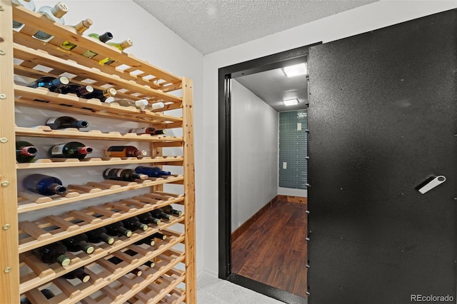 wine area featuring a textured ceiling