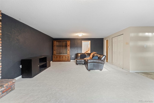 living room with carpet flooring and a textured ceiling