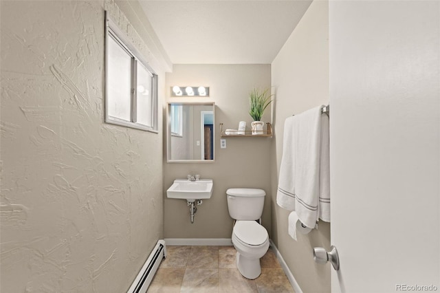 bathroom with a baseboard radiator, toilet, and sink