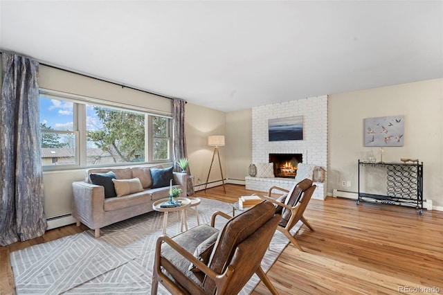 living room with hardwood / wood-style flooring, a fireplace, and a baseboard radiator