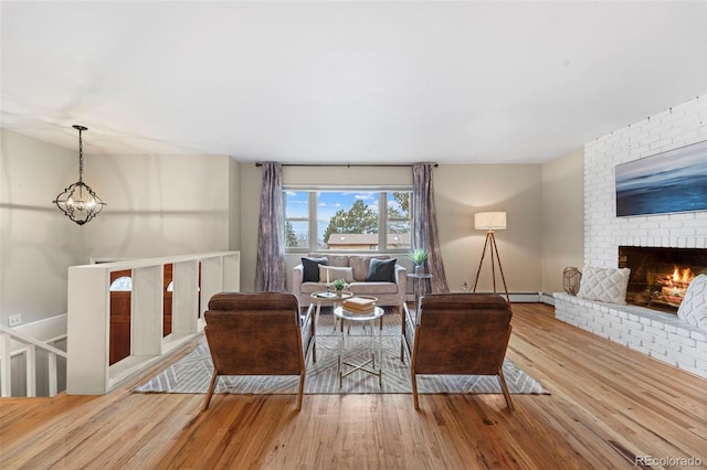 living room featuring hardwood / wood-style flooring and a brick fireplace