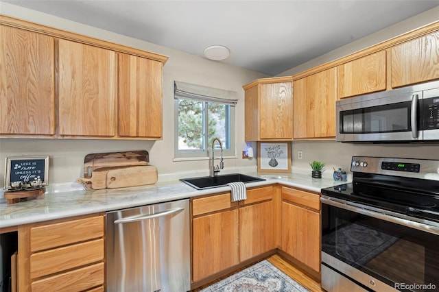 kitchen with sink and appliances with stainless steel finishes