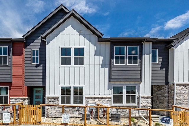 2887 E 103rd Dr, Thornton, CO 80229 - view of front of home featuring board and batten siding, stone siding, and central AC unit