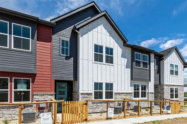 2887 E 103rd Dr, Thornton, CO 80229 - view of front of property featuring board and batten siding, stone siding, and central AC unit