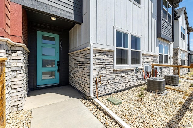 2887 E 103rd Dr, Thornton, CO 80229 - entrance to property with board and batten siding, central AC unit, and stone siding