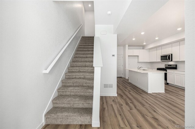 2887 E 103rd Dr, Thornton, CO 80229 - staircase with wood finished floors, recessed lighting, and baseboards