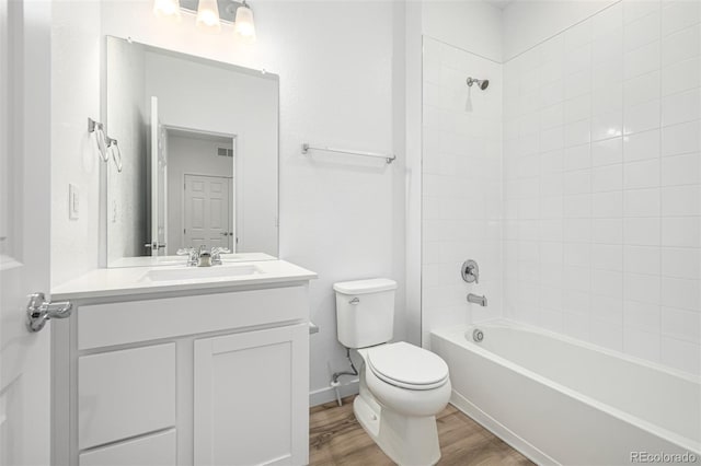 2887 E 103rd Dr, Thornton, CO 80229 - full bath featuring toilet, wood finished floors, vanity, and tub / shower combination