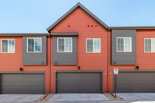 2887 E 103rd Dr, Thornton, CO 80229 - back of house featuring an attached garage and driveway