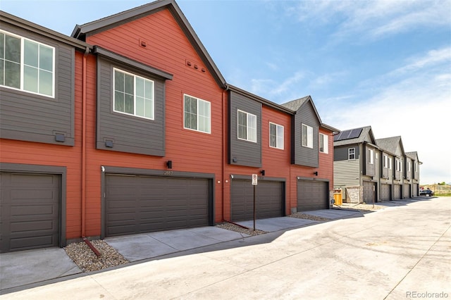 2887 E 103rd Dr, Thornton, CO 80229 - view of side of home with a garage, driveway, and a residential view