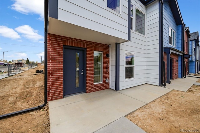 1335 N Alton St, Aurora, CO 80010 - property entrance featuring brick siding