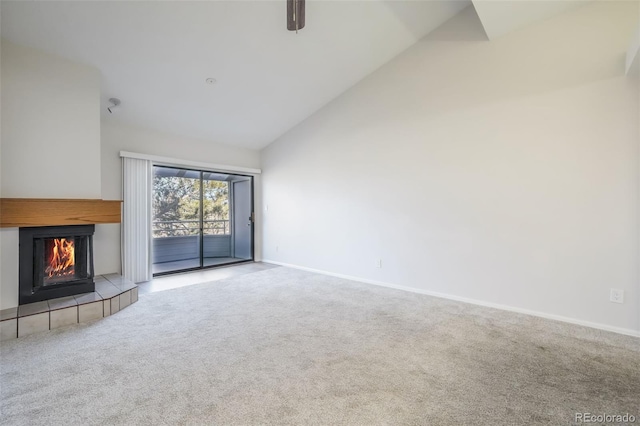 unfurnished living room with carpet, high vaulted ceiling, a fireplace, and ceiling fan