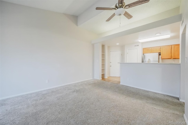 unfurnished living room with light carpet and ceiling fan