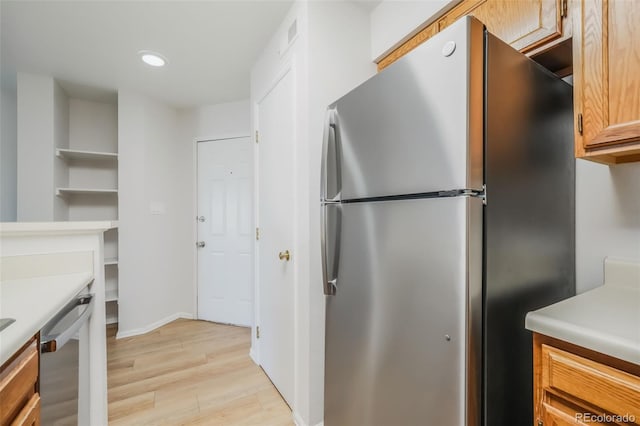 kitchen featuring light hardwood / wood-style floors and appliances with stainless steel finishes