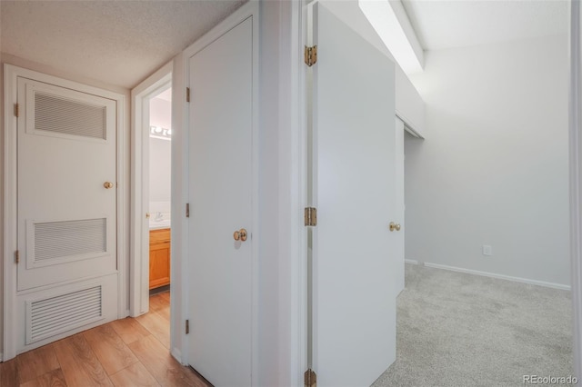 hallway featuring light carpet